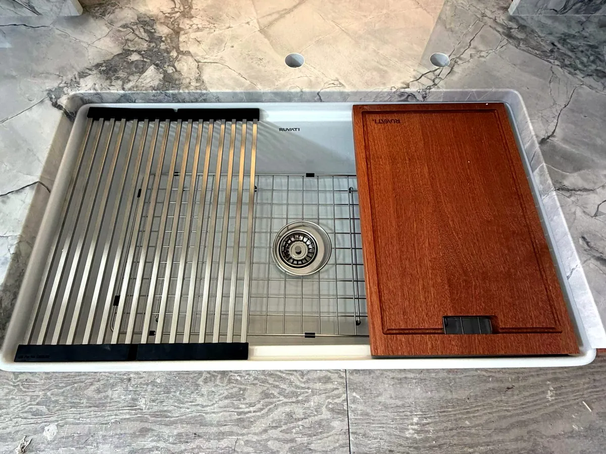 Workstation sink integrated into a natural stone countertop